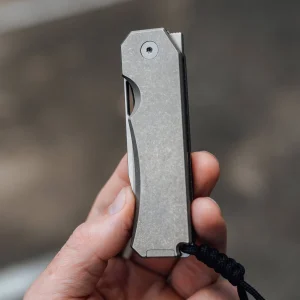 titanium pocket knife closed held in hand grip 1800x1800.webp